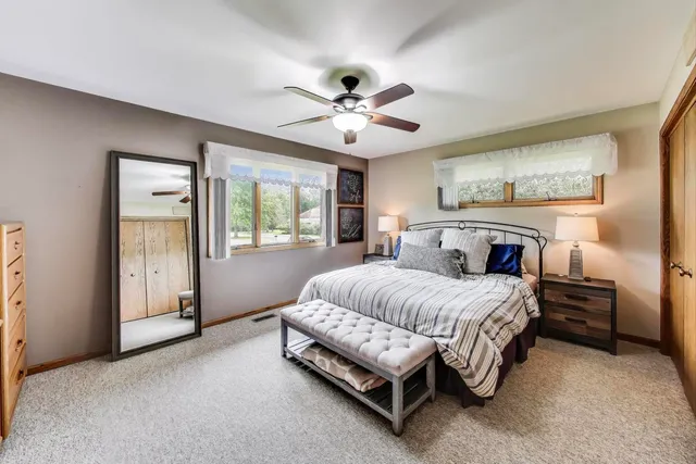 a spacious bedroom with a bed and a chandelier