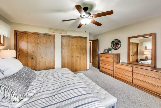 a bedroom with a large bed and a chandelier