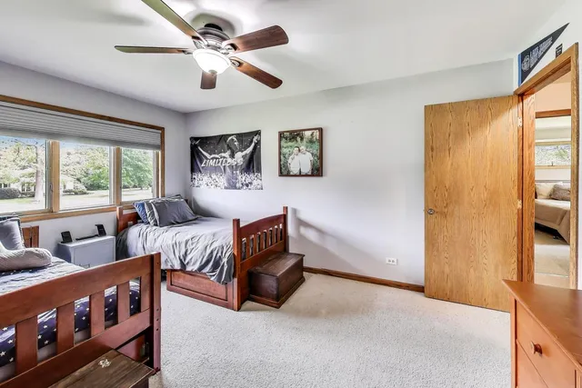 a bedroom with furniture and a large window
