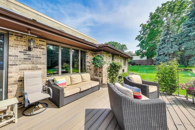 a view of a house with backyard sitting area and garden
