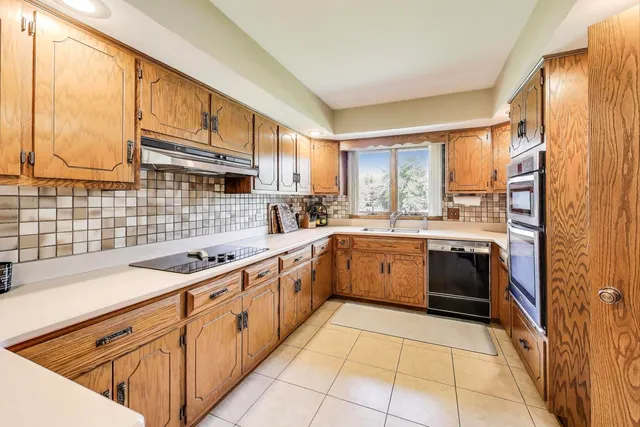 a kitchen with a sink stove and cabinets