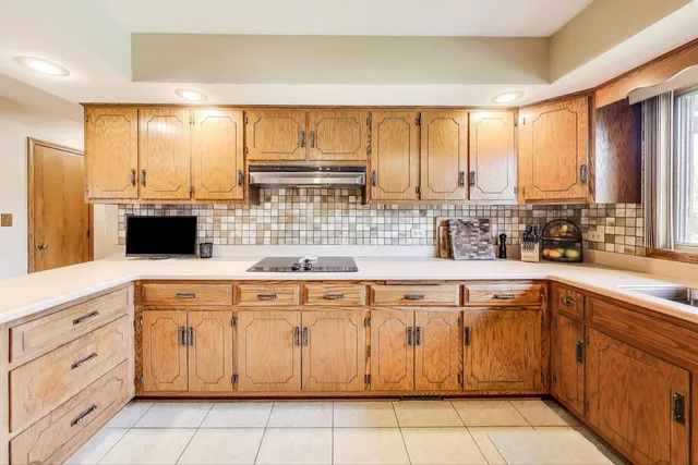 a large kitchen with a large window