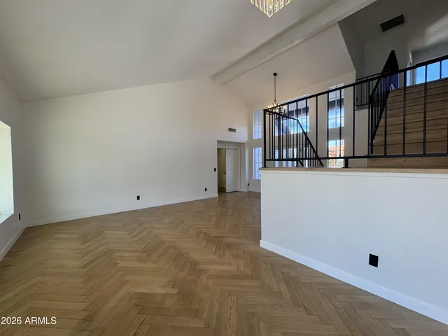 a view of an empty room with a fireplace and a window