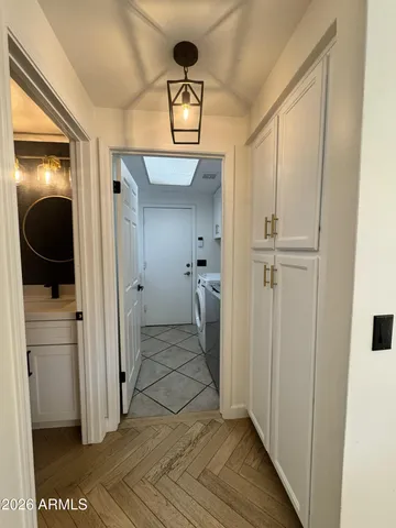 a view of an empty room with a window and fire place