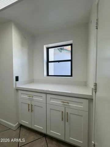 a view of kitchen with refrigerator and stove