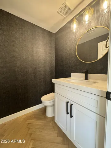 a large white kitchen with a refrigerator and a stove top oven