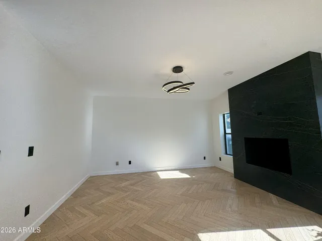 a view of a livingroom with wooden floor and a ceiling fan