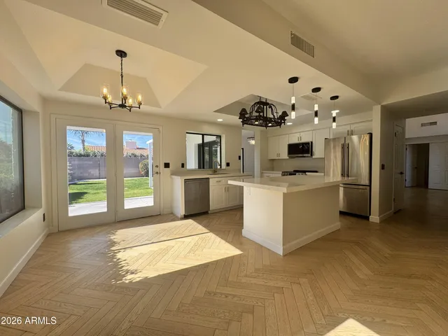 a view of a room with wooden floor and window