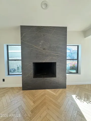 a spacious bathroom with double sink a large mirror and a bathtub