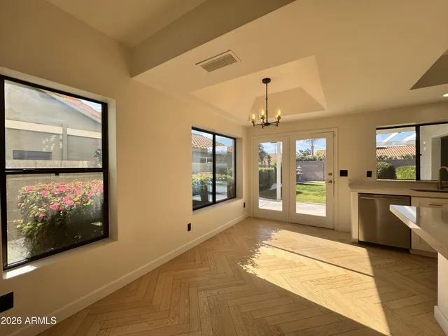 a bathroom with a tub a sink and a large mirror