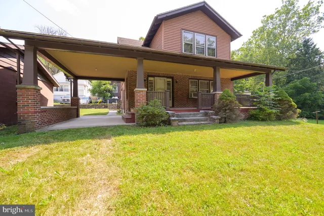 a front view of house with outdoor seating and yard
