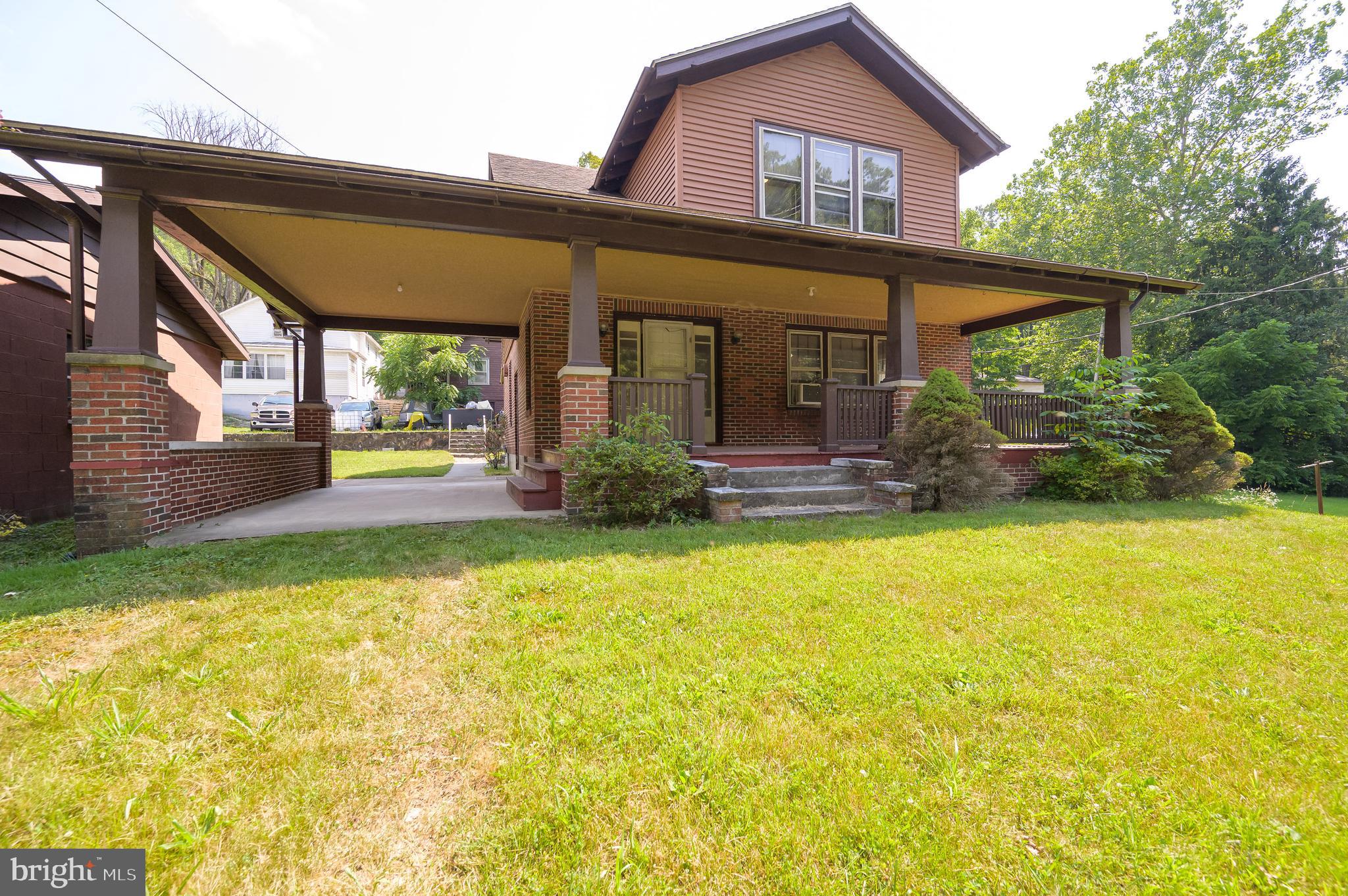 14 Peer Lane Berkeley Springs, WV 25411 - Photo 2 of 52 a front view of house with outdoor seating and yard