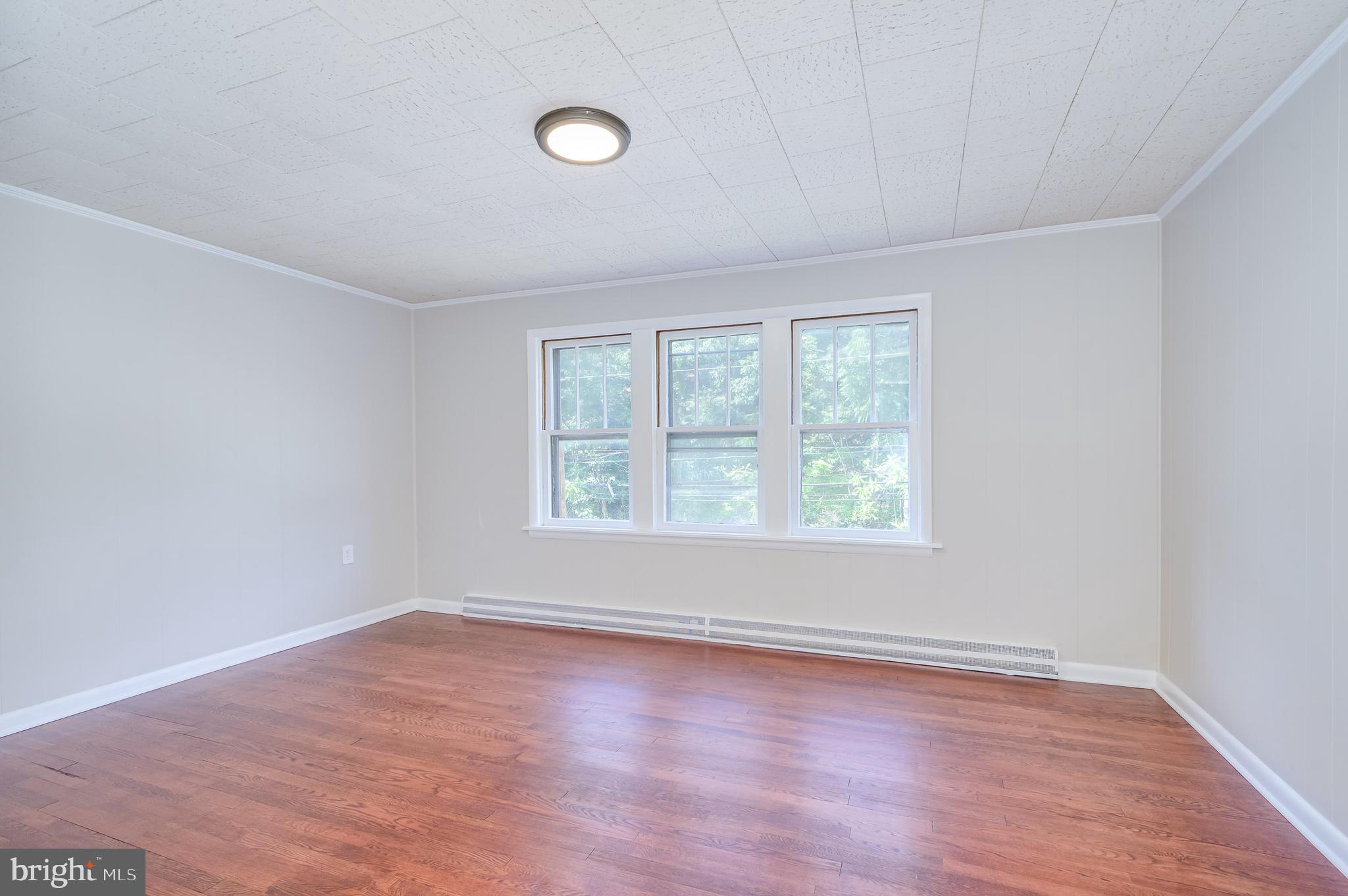 14 Peer Lane Berkeley Springs, WV 25411 - Photo 22 of 52 an empty room with wooden floor and windows
