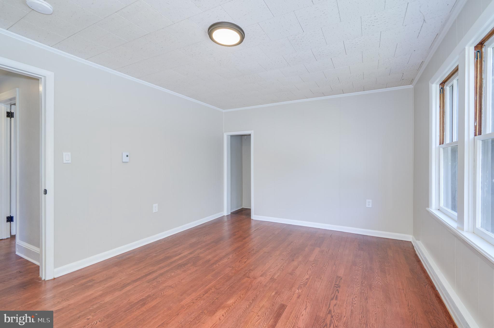 14 Peer Lane Berkeley Springs, WV 25411 - Photo 23 of 52 an empty room with wooden floor and windows