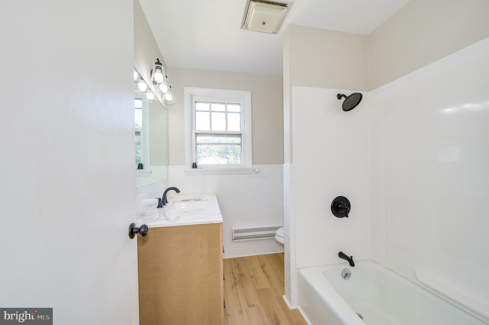 14 Peer Lane Berkeley Springs, WV 25411 - Photo 30 of 52 a bathroom with a tub sink and mirror