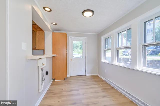 a bathroom with a sink vanity mirror and toilet