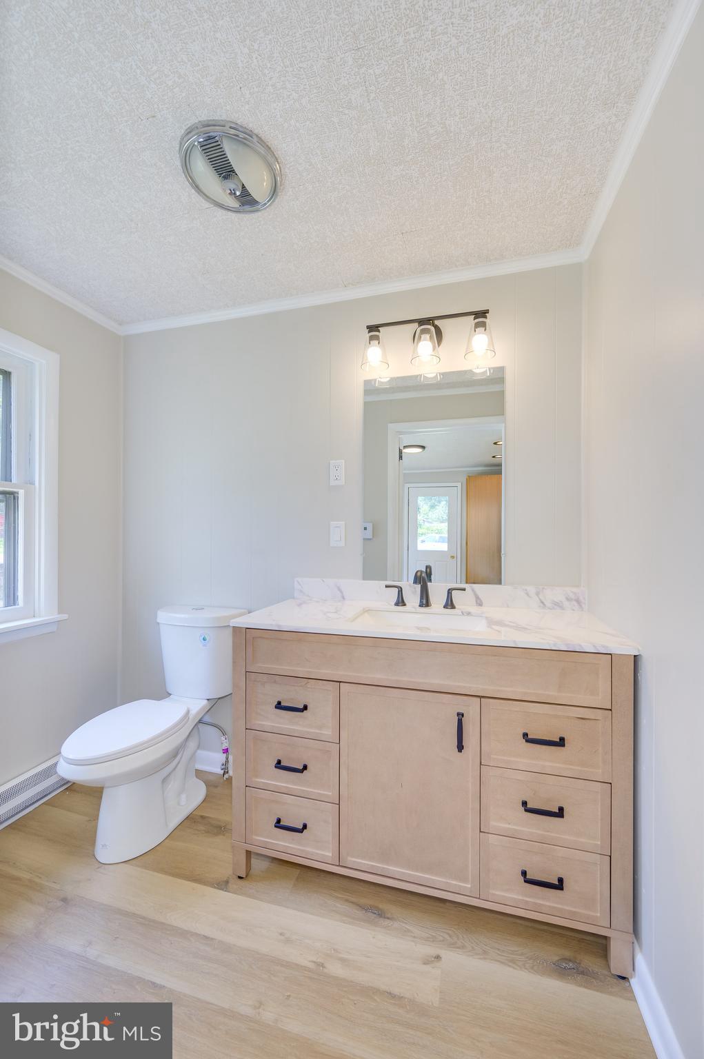14 Peer Lane Berkeley Springs, WV 25411 - Photo 6 of 52 a bathroom with a sink a toilet and a mirror