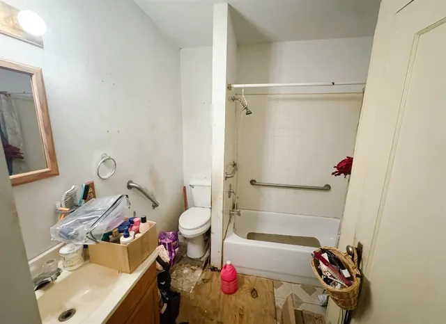 a bathroom with a sink toilet and shower