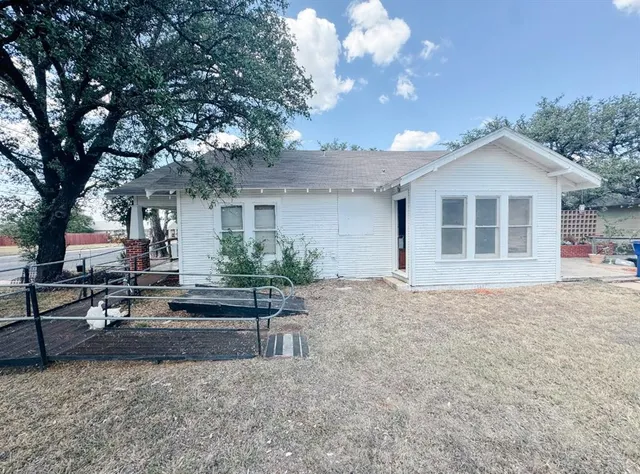 a house view with a sitting space and garden
