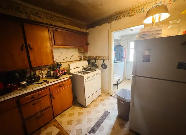 a view of a kitchen with sink washer and dryer