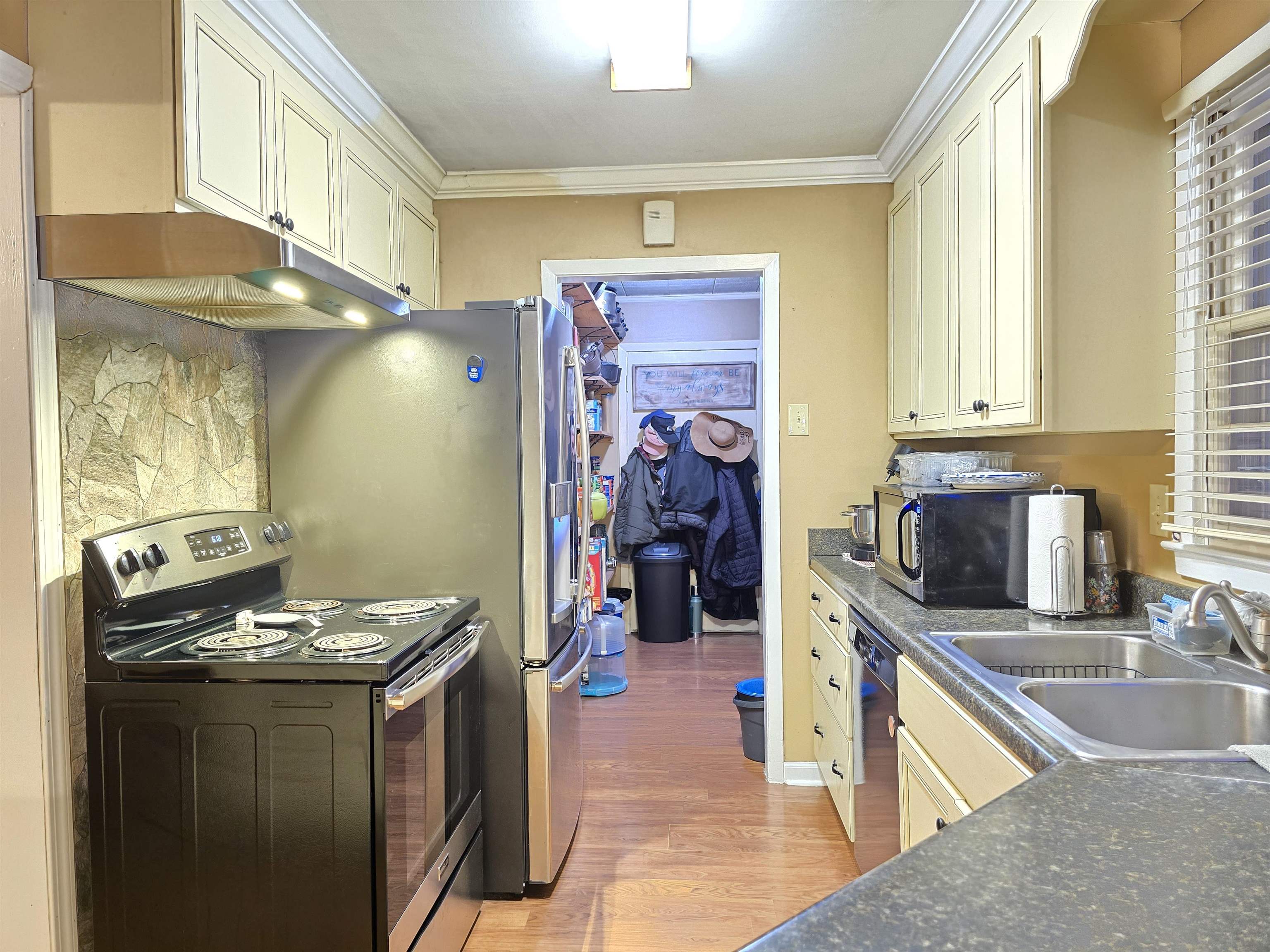 4885 Macon Road Memphis, TN 38122 - Photo 20 of 39 a kitchen with stainless steel appliances granite countertop a sink stove and refrigerator