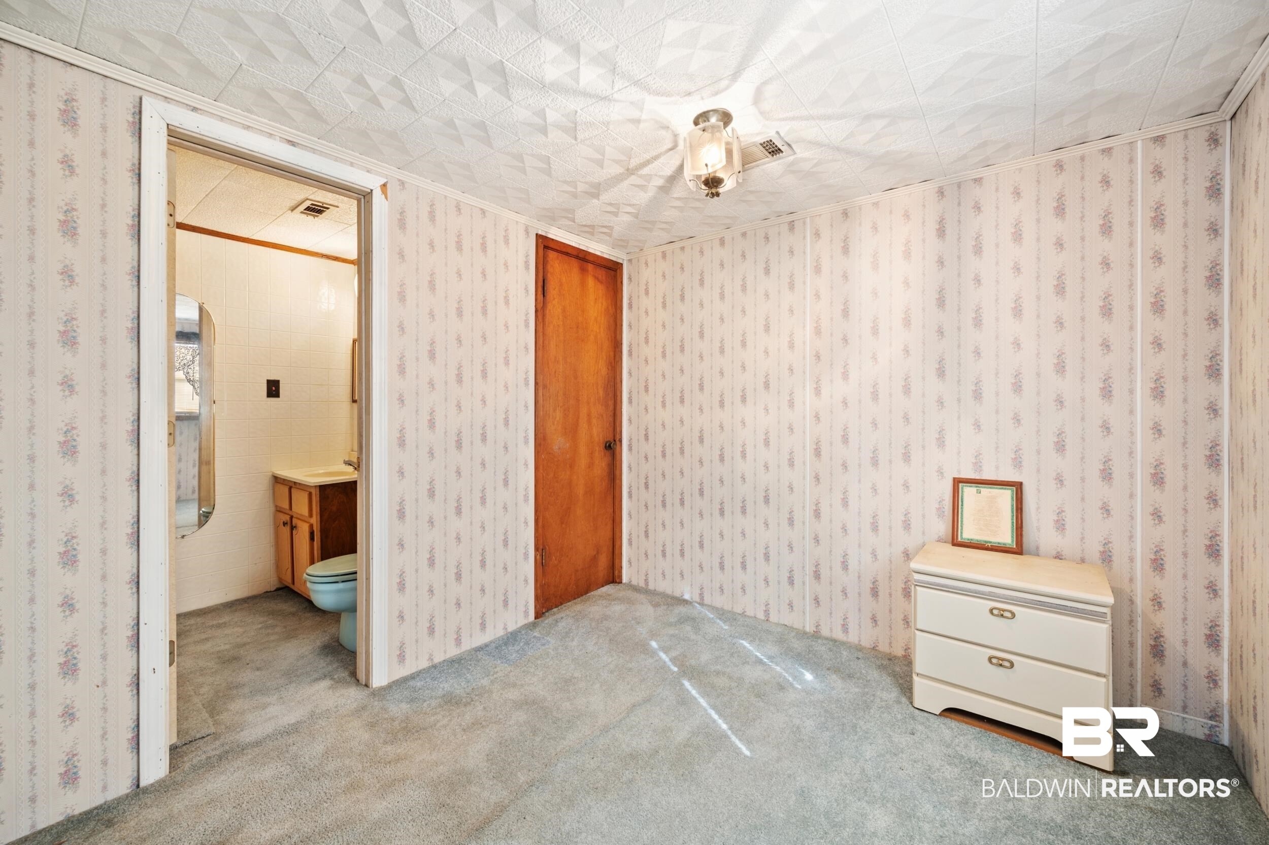 57623 Mary Hadley Road Perdido, AL 36562 - Photo 18 of 34 Unfurnished bedroom featuring connected bathroom and carpet
