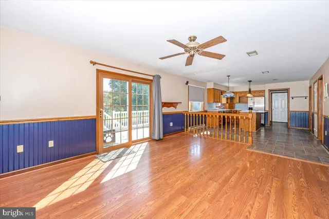 a very nice looking kitchen with granite countertop a stove a sink a window and a dining table
