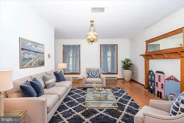 a living room with furniture a clock and a window