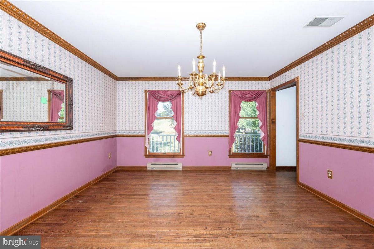 4 Shifflett Place Smithsburg, MD 21783 - Photo 26 of 57 a view of a room with window chandelier and wooden floor