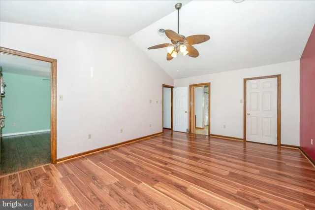 a bathroom with a granite countertop sink toilet a mirror and shower