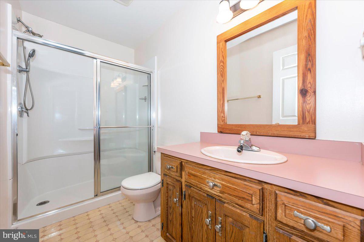4 Shifflett Place Smithsburg, MD 21783 - Photo 34 of 57 a bathroom with a granite countertop sink toilet a mirror and shower