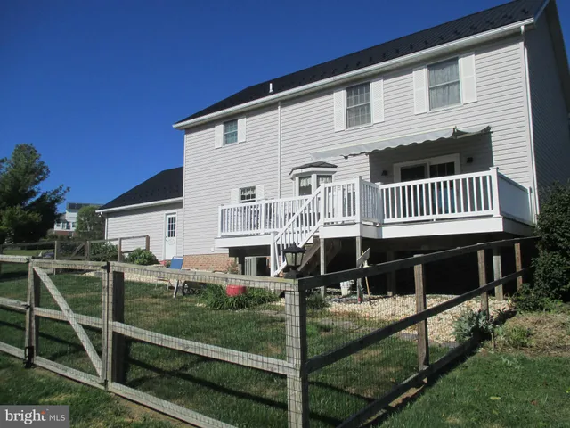 a front view of a house with a yard table and chairs