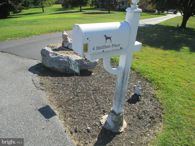 a front view of a house with a yard fire pit and outdoor seating