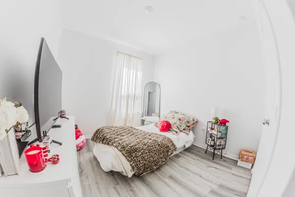 a bedroom with a bed and a potted plant