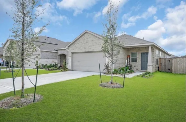 a house view with a garden space and backyard
