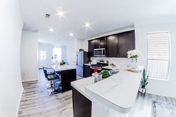 a view of a dining room with furniture and wooden floor