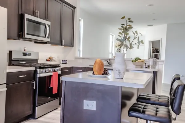 a kitchen with a sink appliances and cabinets