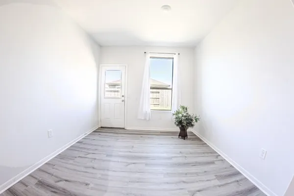 a view of a room with wooden floor
