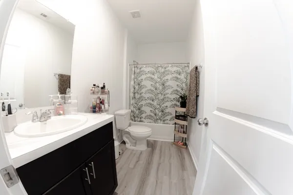 a bathroom with a sink a toilet and a mirror