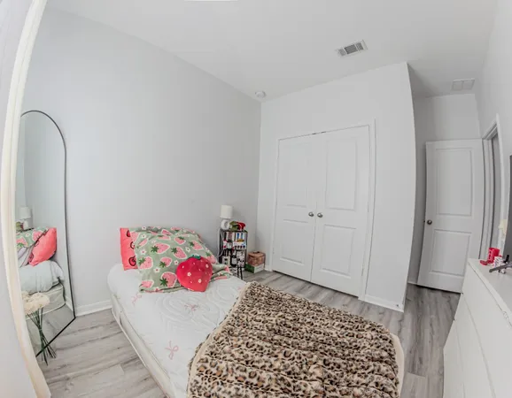 a bedroom with a bed and a dresser