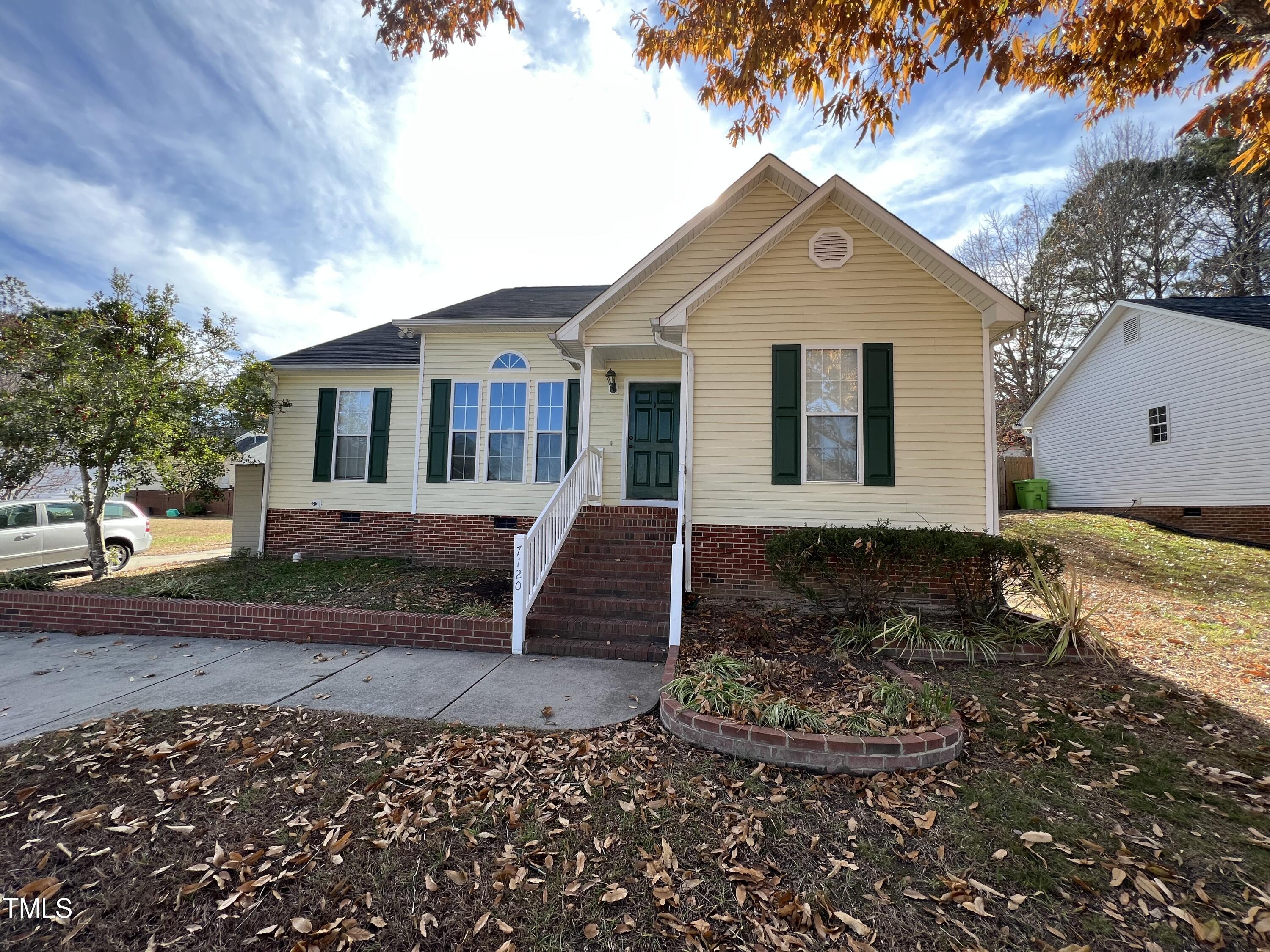 7120 Spanglers Spring Way Raleigh, NC 27610 - Photo 1 of 18 a front view of a house with a yard