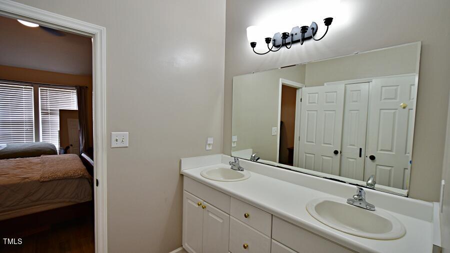 7120 Spanglers Spring Way Raleigh, NC 27610 - Photo 11 of 18 a bathroom with a sink and a mirror