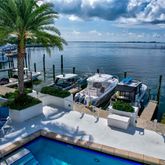 a view of a backyard with plants and outdoor seating
