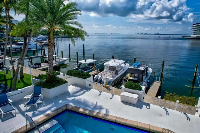 a view of a backyard with plants and outdoor seating