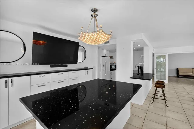 a kitchen with cabinets and stainless steel appliances