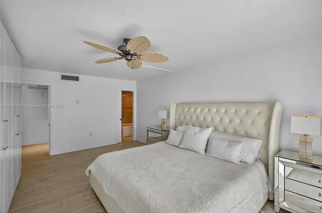 a bedroom with a bed and a ceiling fan