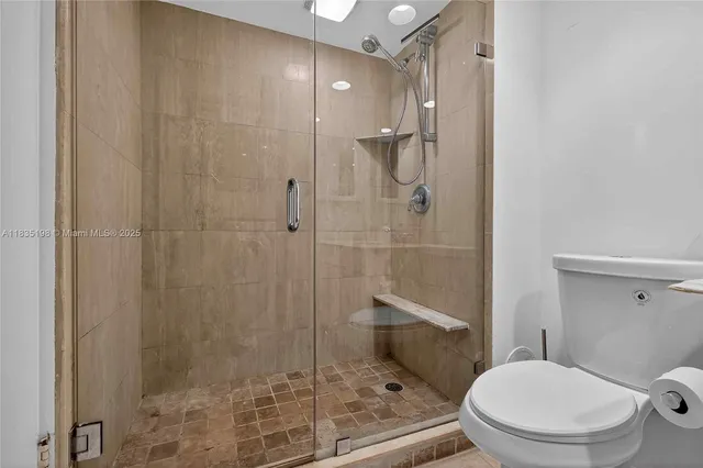 a bathroom with a sink mirror and toilet