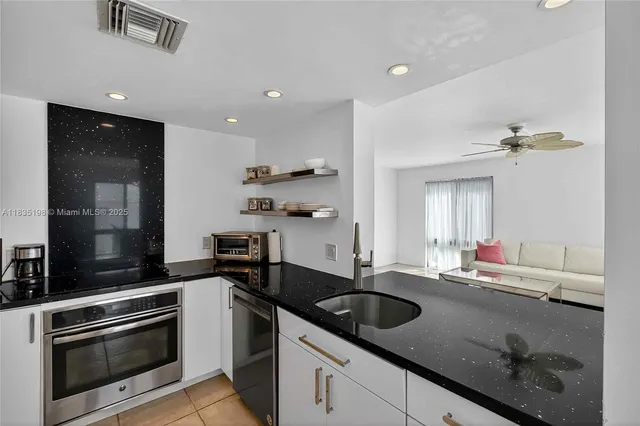 a kitchen with a sink dishwasher a stove and a refrigerator with wooden floor