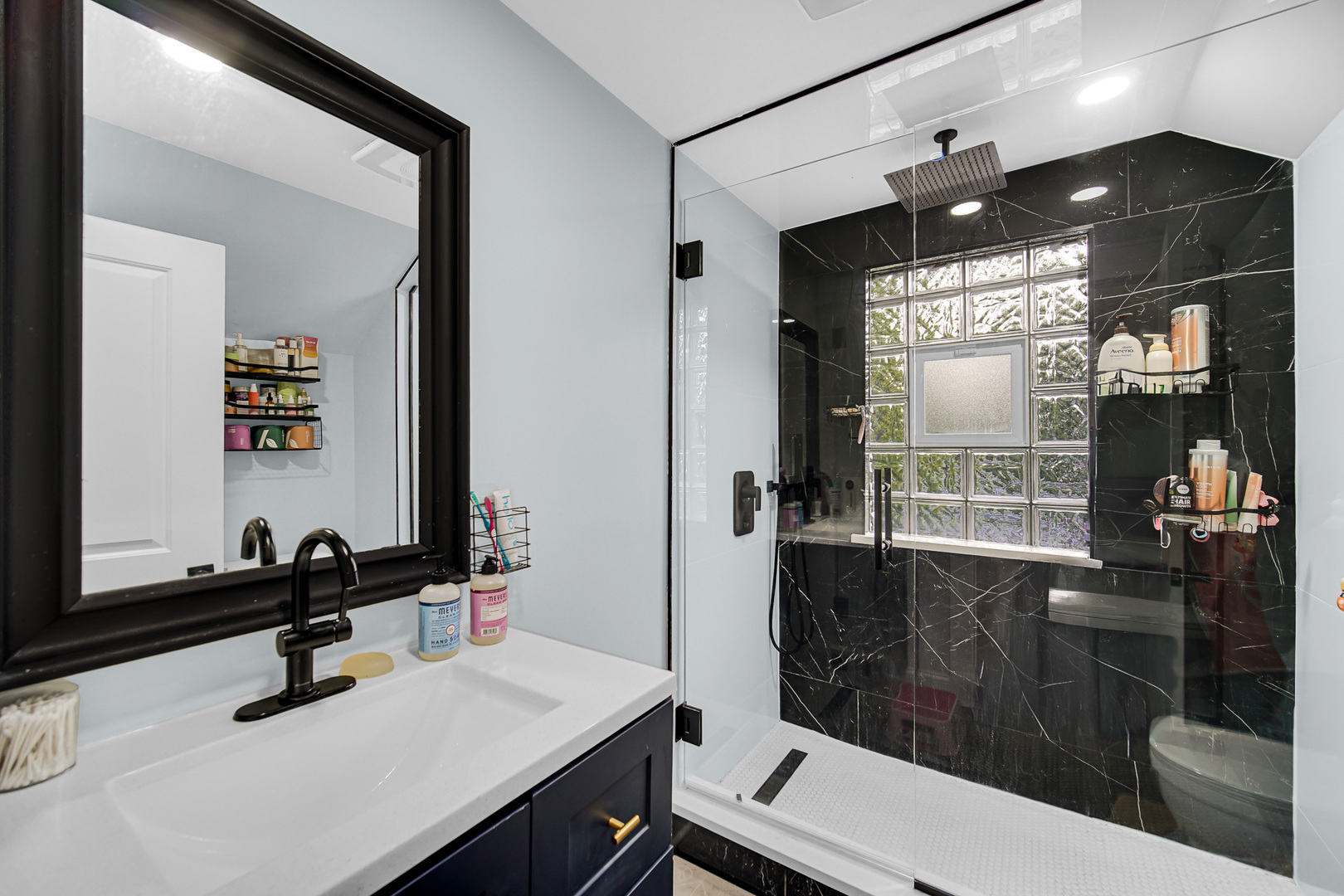 1521 Catalpa Street Waukegan, IL 60085 - Photo 14 of 22 a bathroom with a sink a toilet a mirror and shower