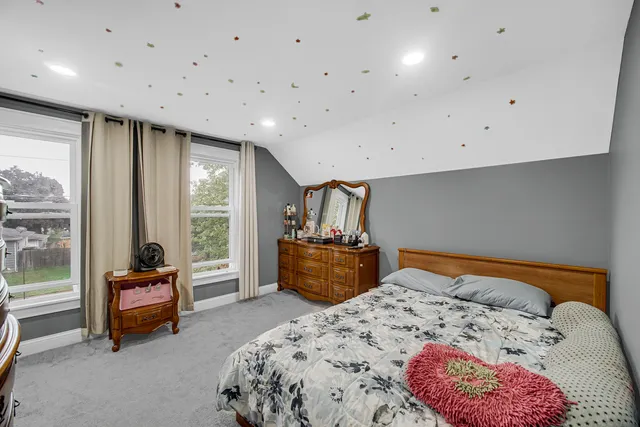 a bedroom with a bed and a couch